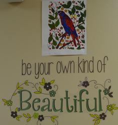 A picture of a blue and red bird above the text “be your own kind of Beautiful”